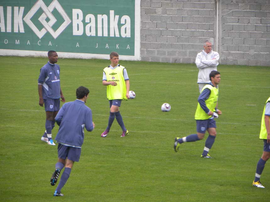 Head Coach John Peacock watches his side train in Serbia.